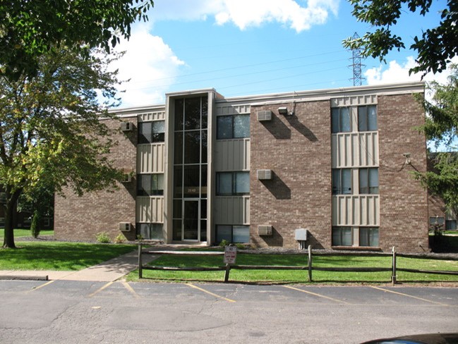 View of exterior of apartment building and parking lot