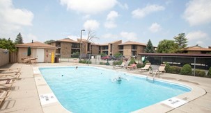 View of pool and exterior of apartment building