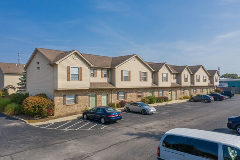 Exterior view of apartment building and parking lot 3